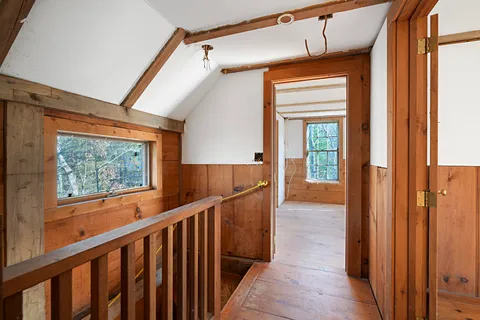 a view of empty room with wooden floor and cabinet