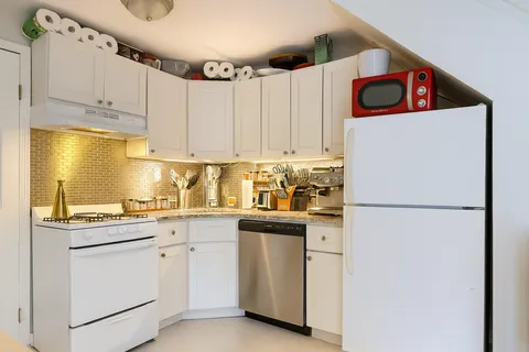 a white refrigerator freezer sitting inside of a kitchen
