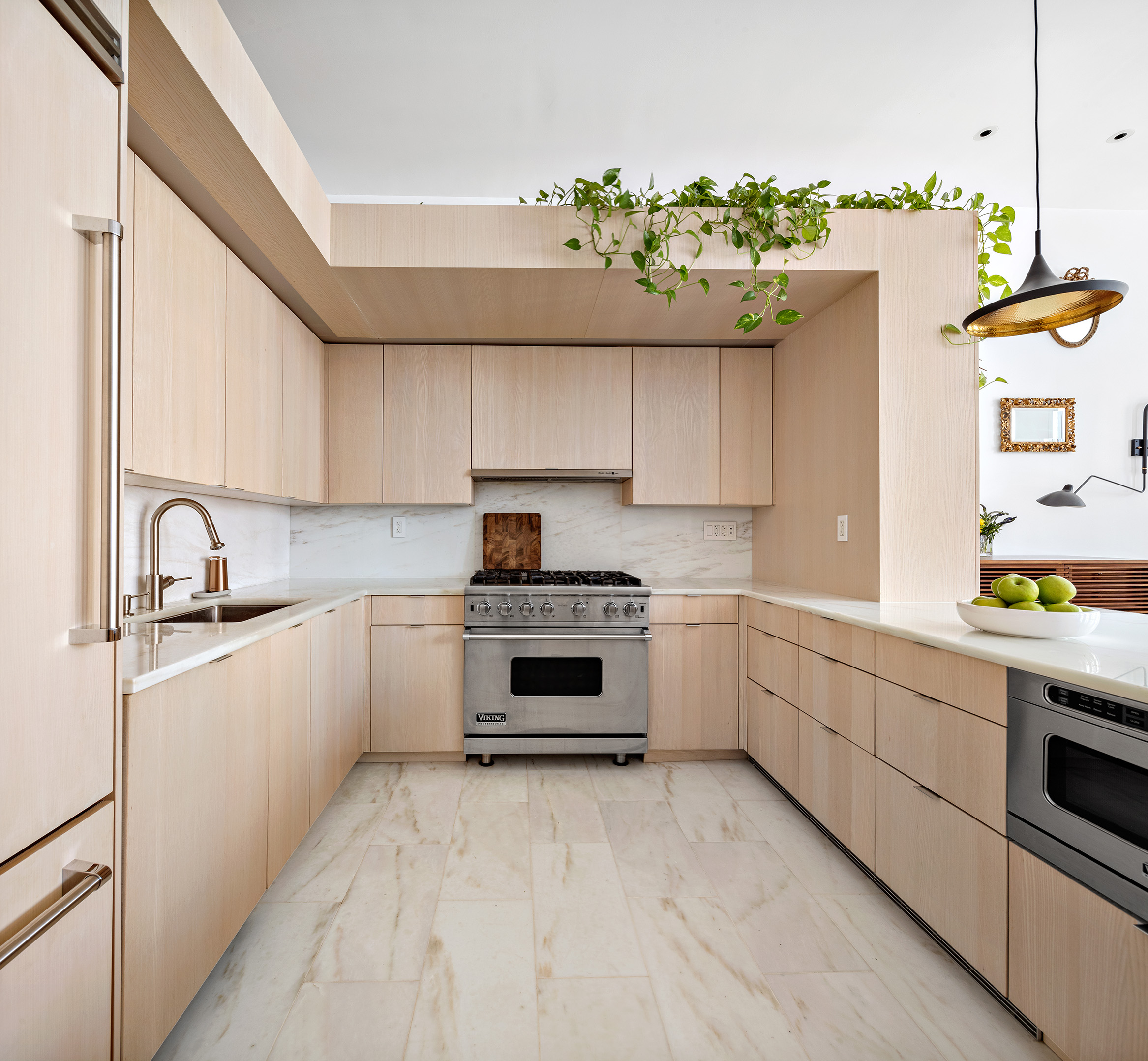 93 Reade Street, Unit 3 Manhattan, NY 10013 - Photo 4 of 12 a kitchen with kitchen island granite countertop a white stove top oven and sink