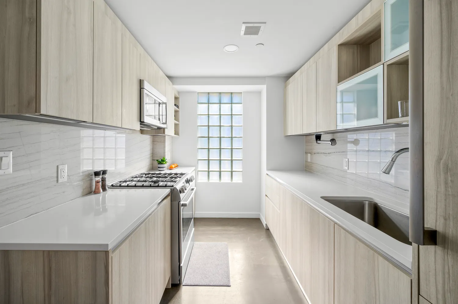 a kitchen with a sink stove top oven and cabinets