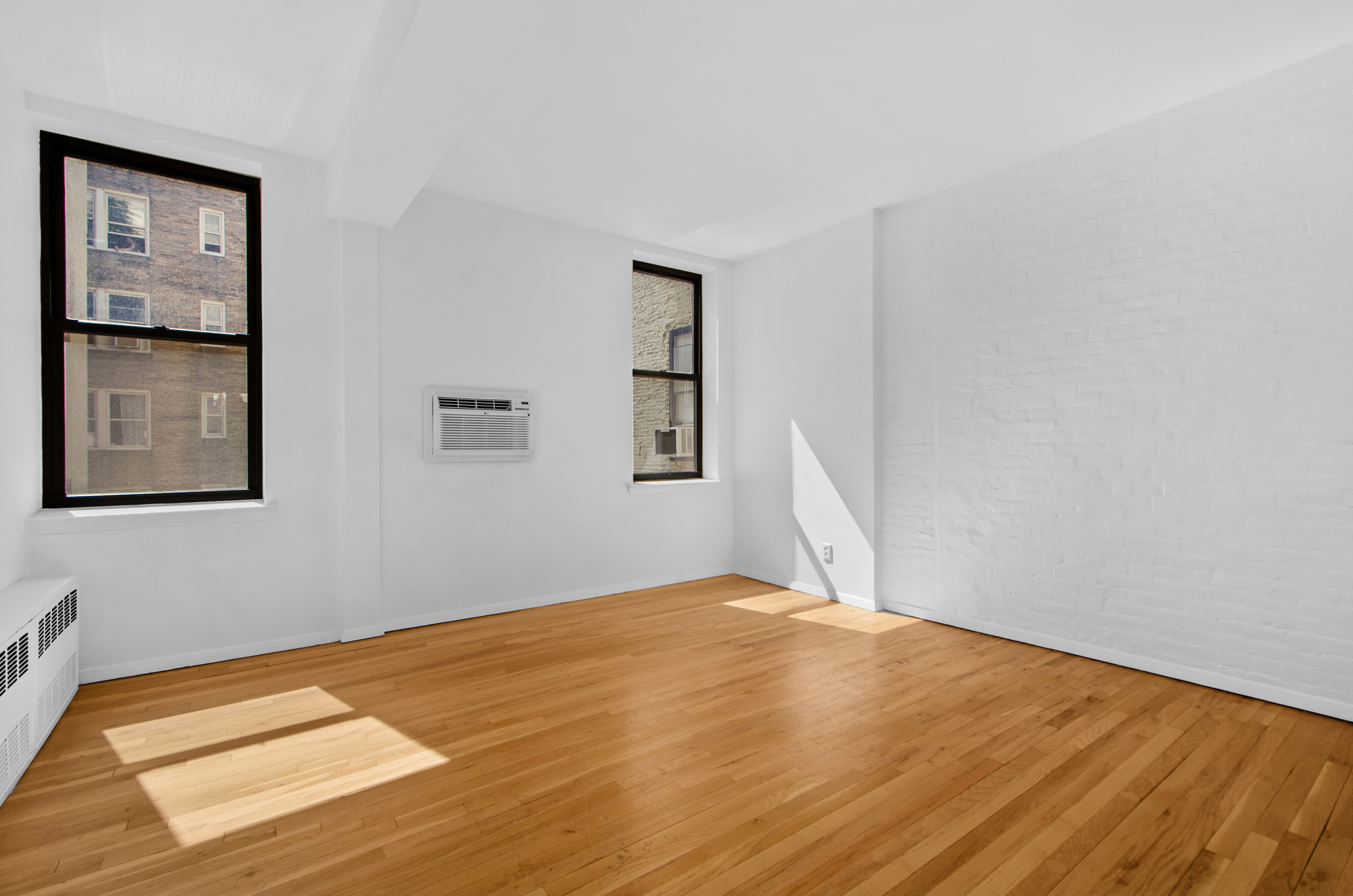 23 East 10th Street, Unit 5A Manhattan, NY 10003 - Photo 5 of 9 a view of a big room with wooden floor and windows
