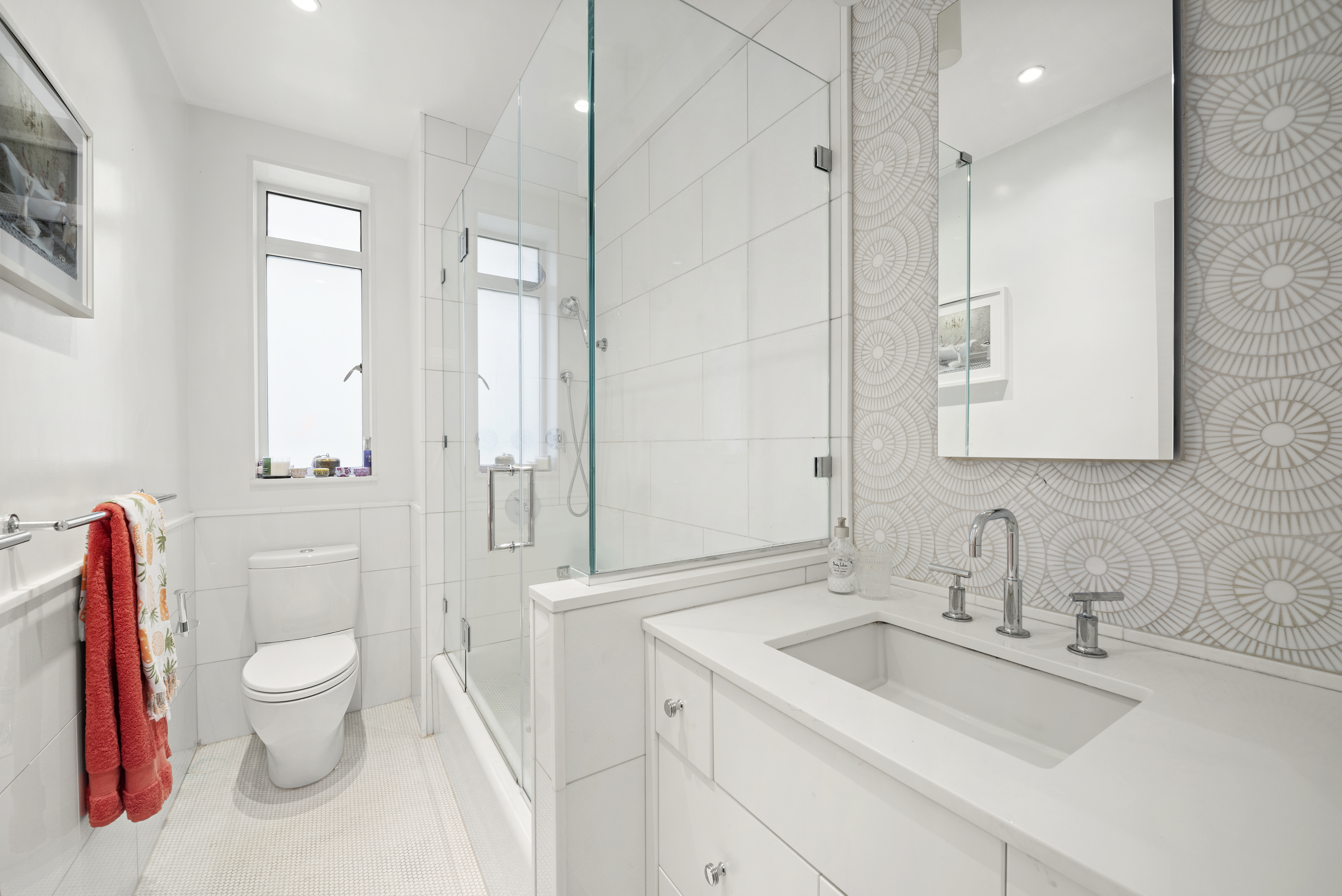 25 Central Park West, Unit 2W Manhattan, NY 10023 - Photo 5 of 12 a bathroom with a sink toilet vanity and shower