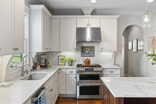 a kitchen with a sink stove and refrigerator