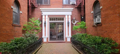 front view of a house with potted plants