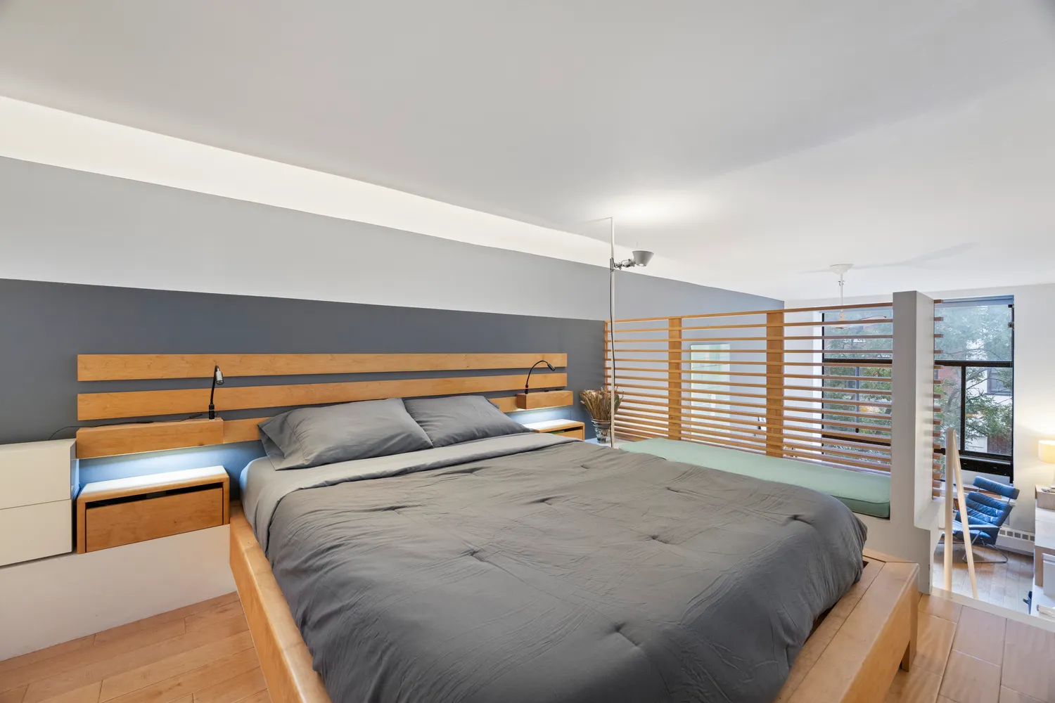 a bedroom with a bed and a large window