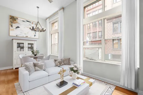 a living room with furniture and a chandelier