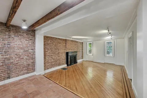 a view of an empty room with a fireplace and a window
