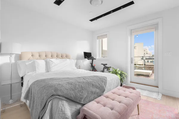 a bedroom with two beds and painted walls