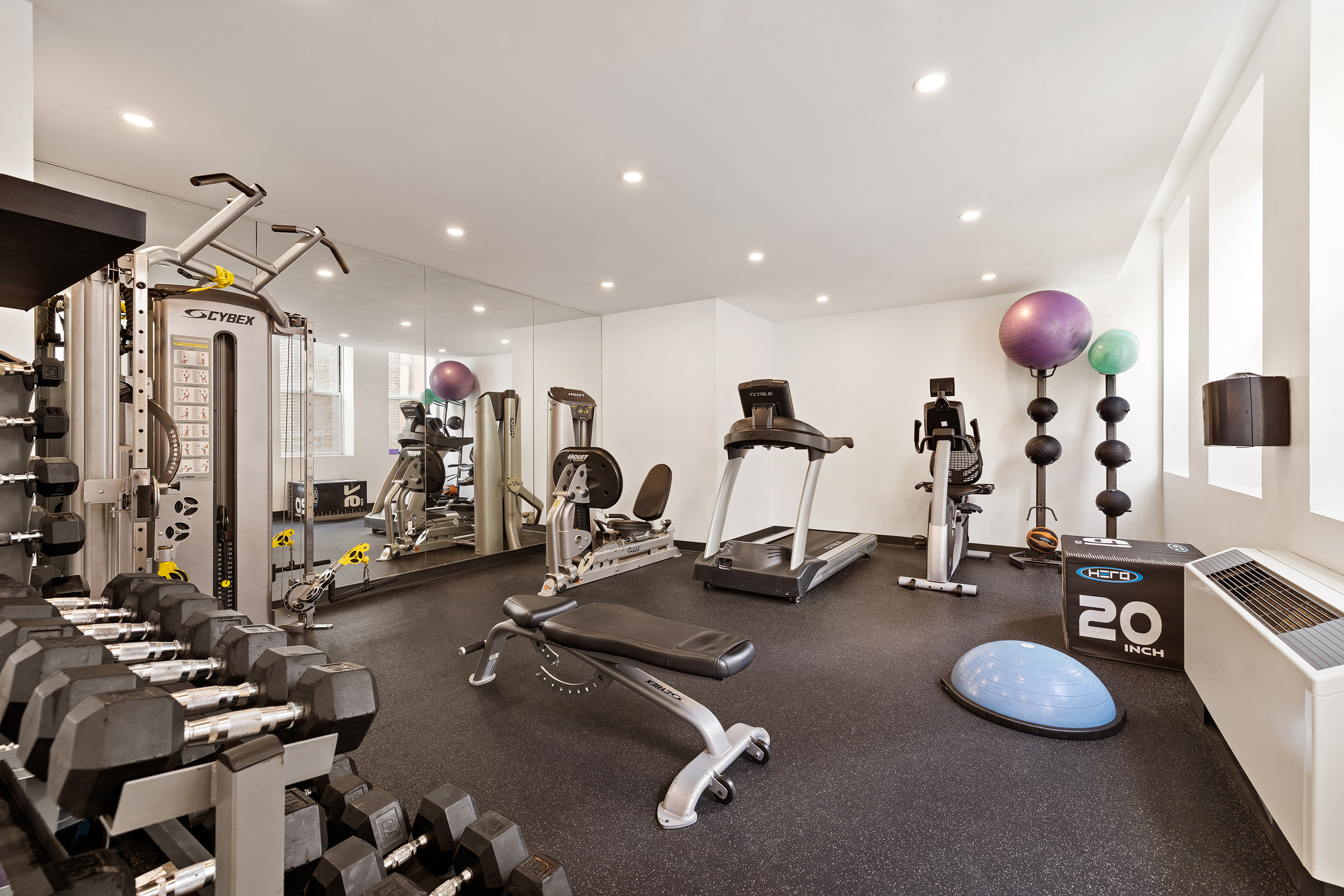 80 Chambers Street, Unit 11A Manhattan, NY 10007 - Photo 16 of 24 a room with gym equipment and mirrors