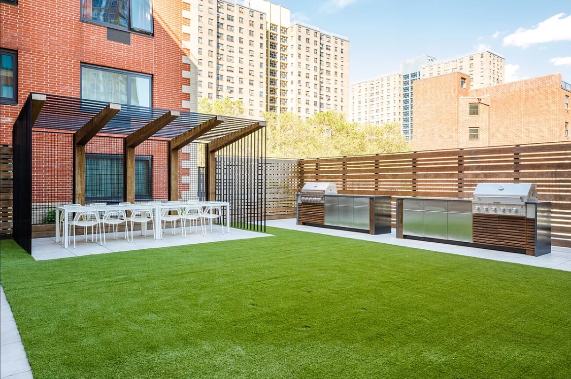 1330 5th Avenue, Unit 6H Manhattan, NY 10026 - Photo 7 of 11 a view of a house with a yard and sitting area