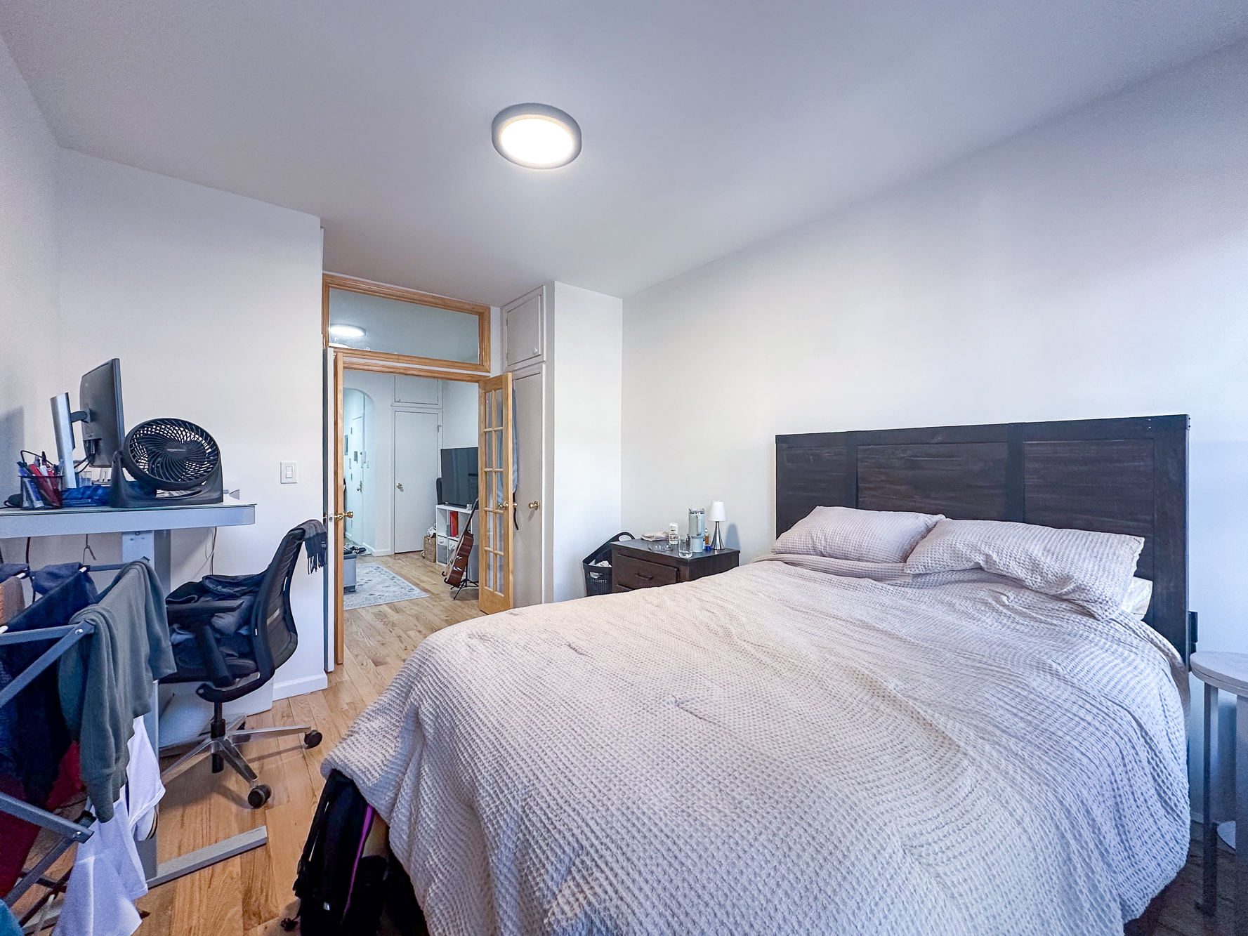 342 East 9th Street, Unit 3B Manhattan, NY 10003 - Photo 3 of 9 a bedroom with a bed a mirror and lamp on desk