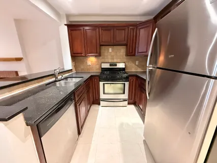 a kitchen with a refrigerator sink and stove
