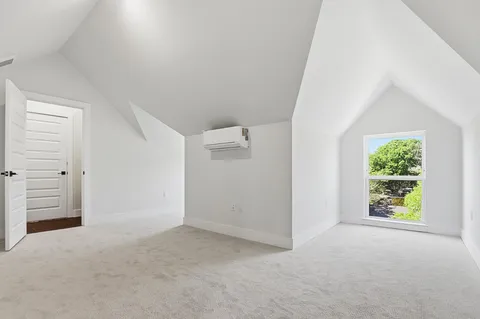 an empty room with windows and closet