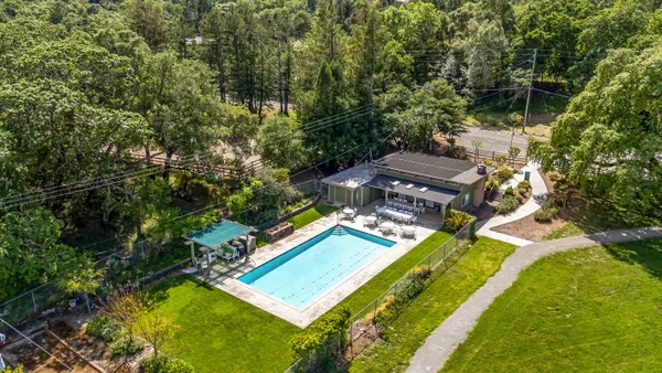an aerial view of a house with a yard