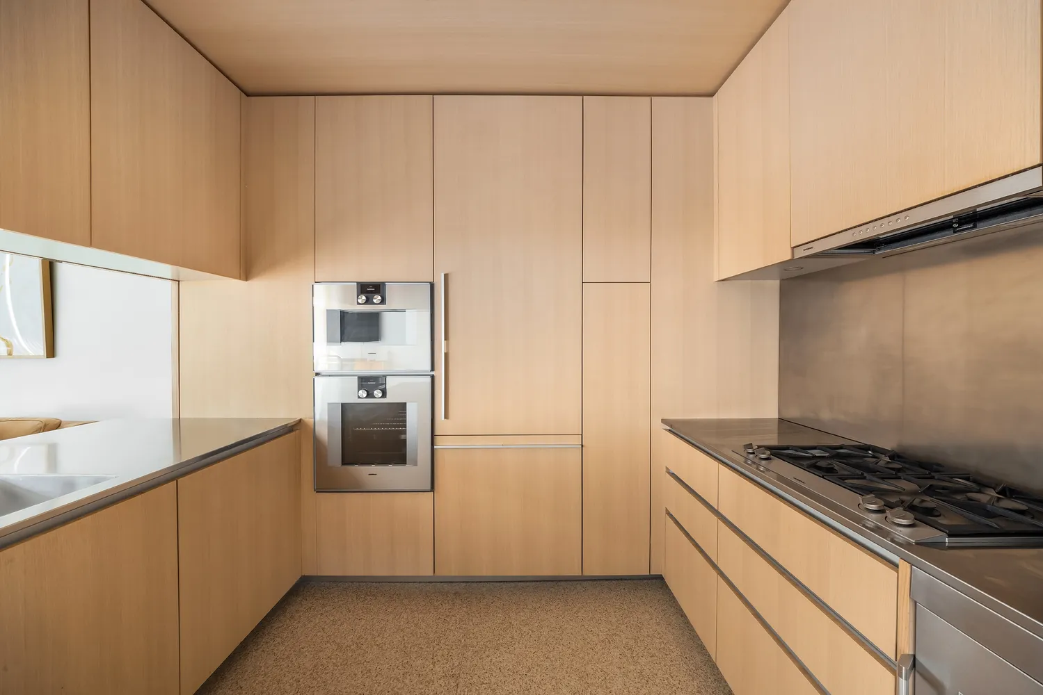 a kitchen with stainless steel appliances granite countertop a refrigerator and a stove