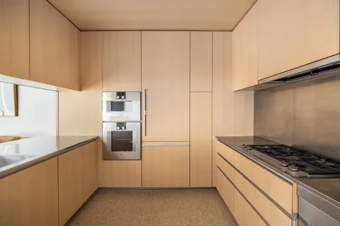 a kitchen with stainless steel appliances granite countertop a refrigerator and a stove