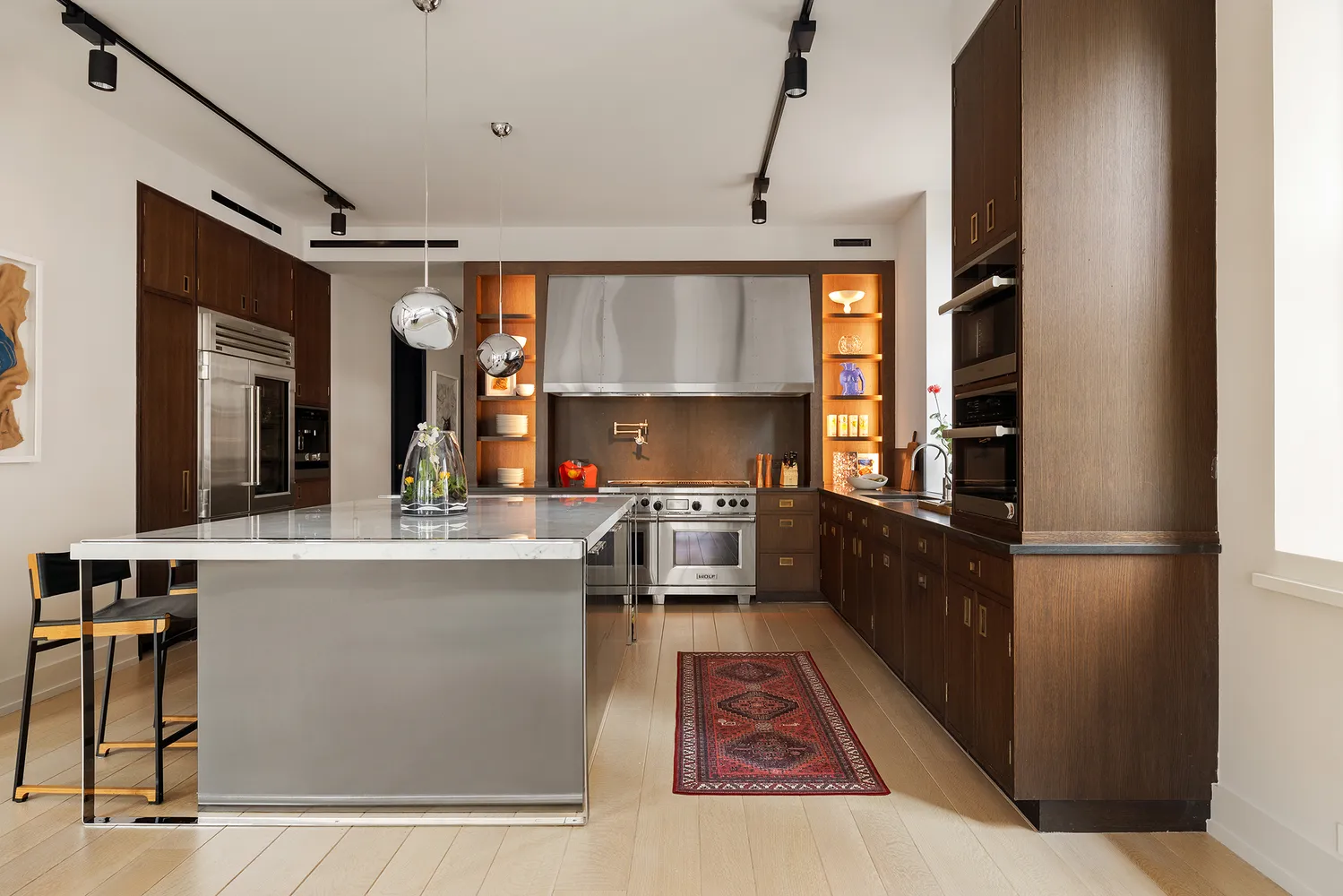 a kitchen with stainless steel appliances granite countertop a refrigerator and a stove top oven