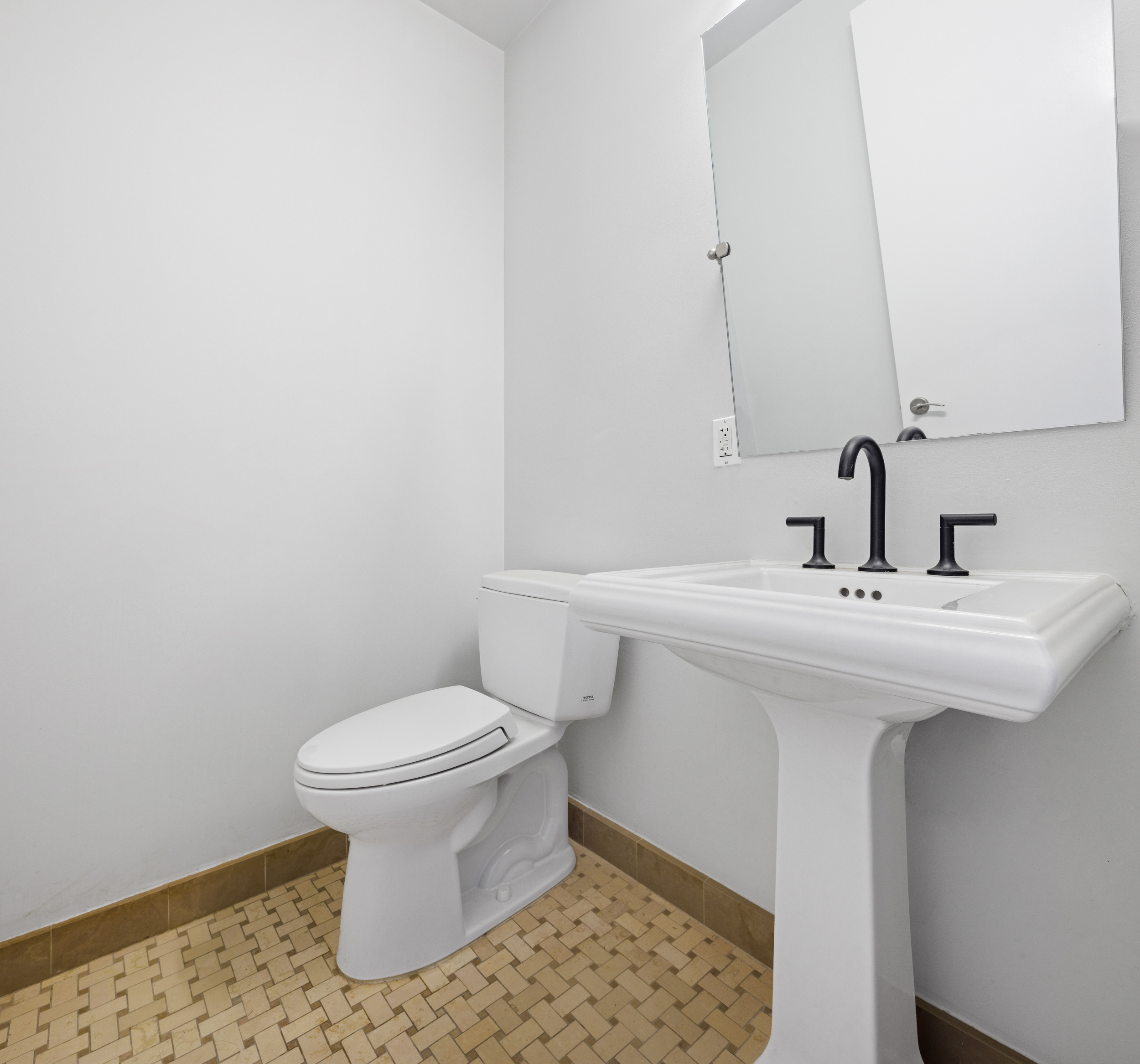 34 Leonard Street, Unit 7A Manhattan, NY 10013 - Photo 9 of 17 a bathroom with a sink toilet and a mirror