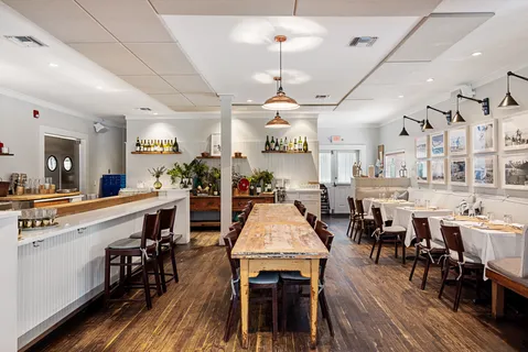 a large kitchen with a table and chairs