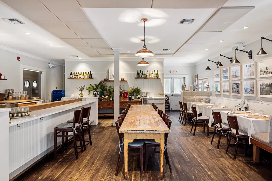 a large kitchen with a table and chairs