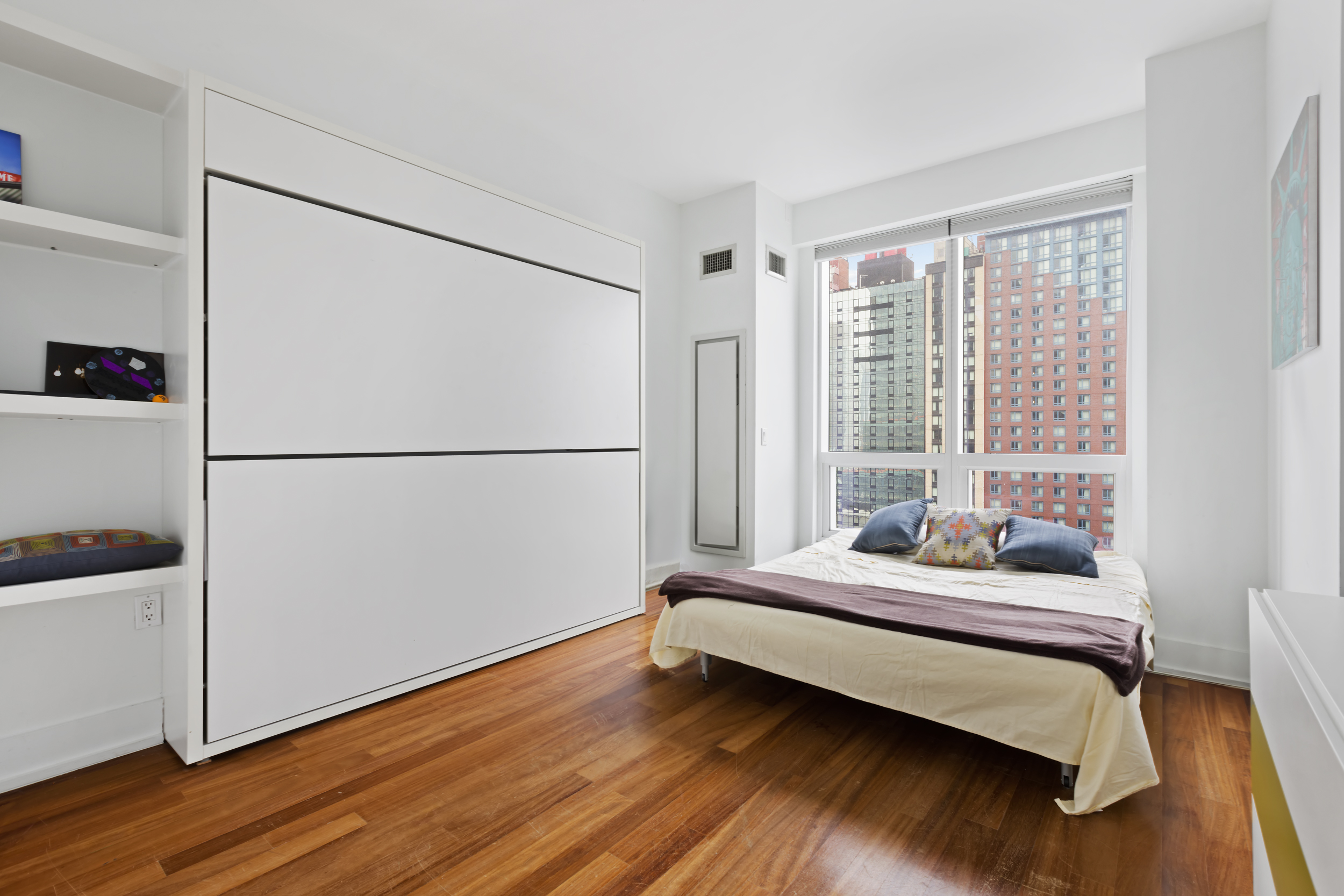 350 West 42nd Street, Unit 20L Manhattan, NY 10036 - Photo 9 of 11 a bedroom with a bed and a window