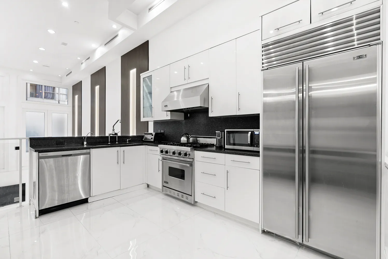 a view of a hallway with dining area and chandelier