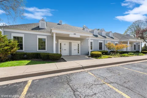 a front view of a house with a garden and pathway
