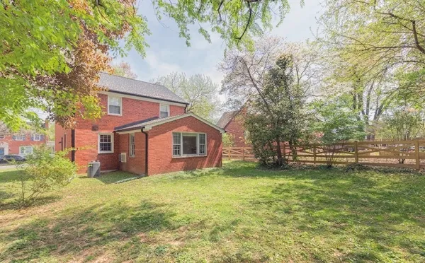 a view of a house with backyard sitting area and garden