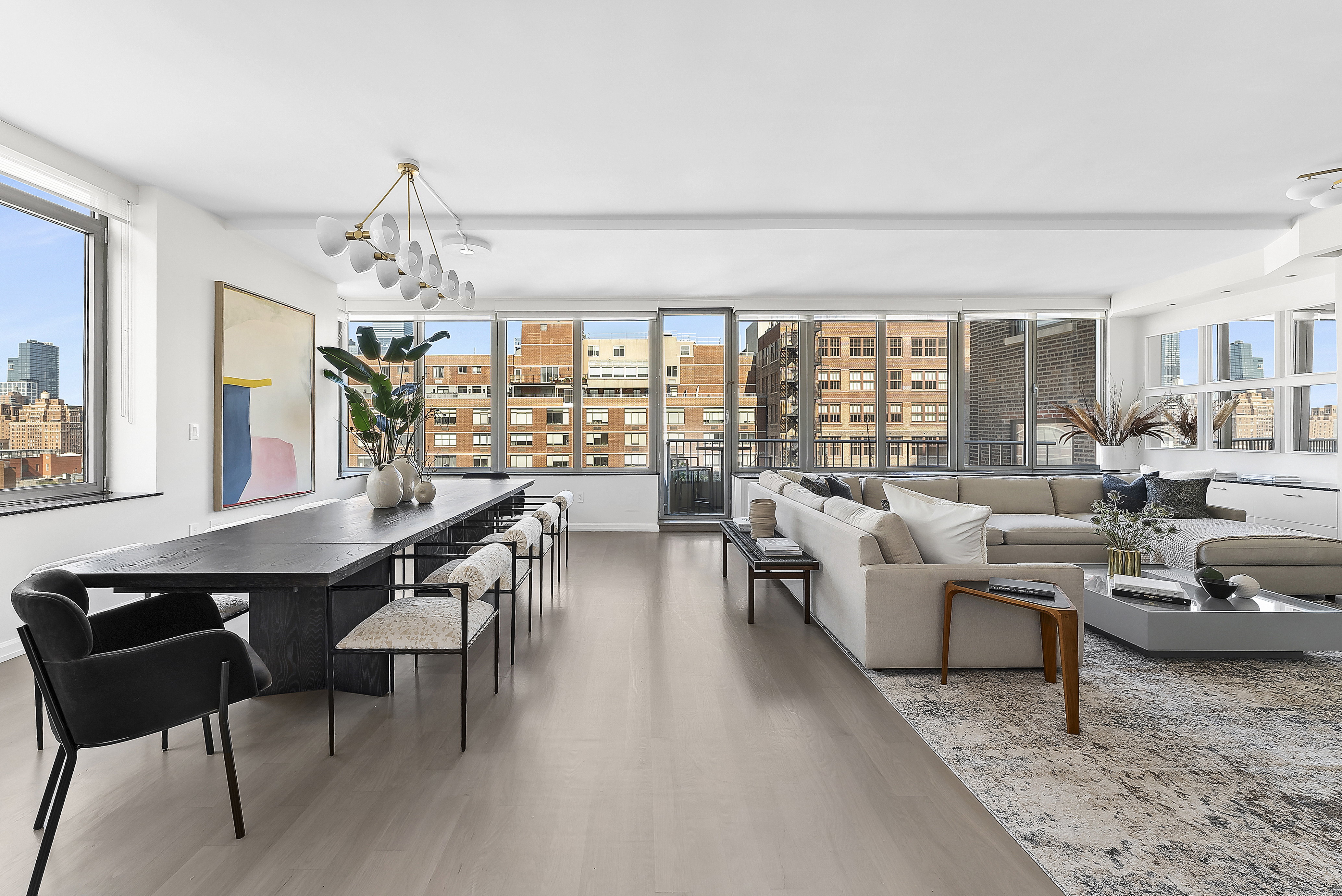 224 West 18th Street, Unit PHA Manhattan, NY 10011 - Photo 1 of 24 a living room with furniture and a chandelier