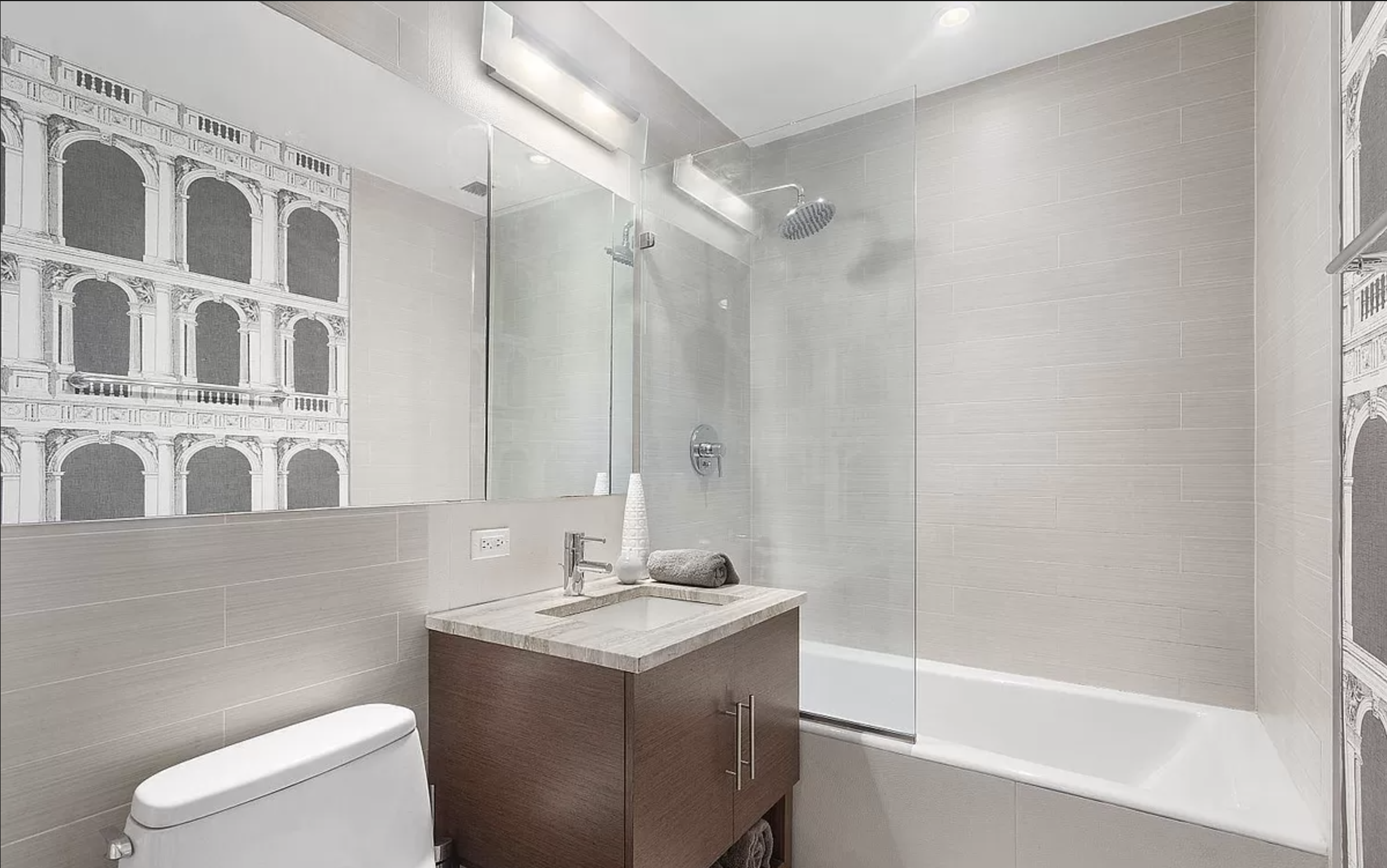 505 West 47th Street, Unit 1DS Manhattan, NY 10036 - Photo 3 of 8 a bathroom with a sink a toilet and a shower