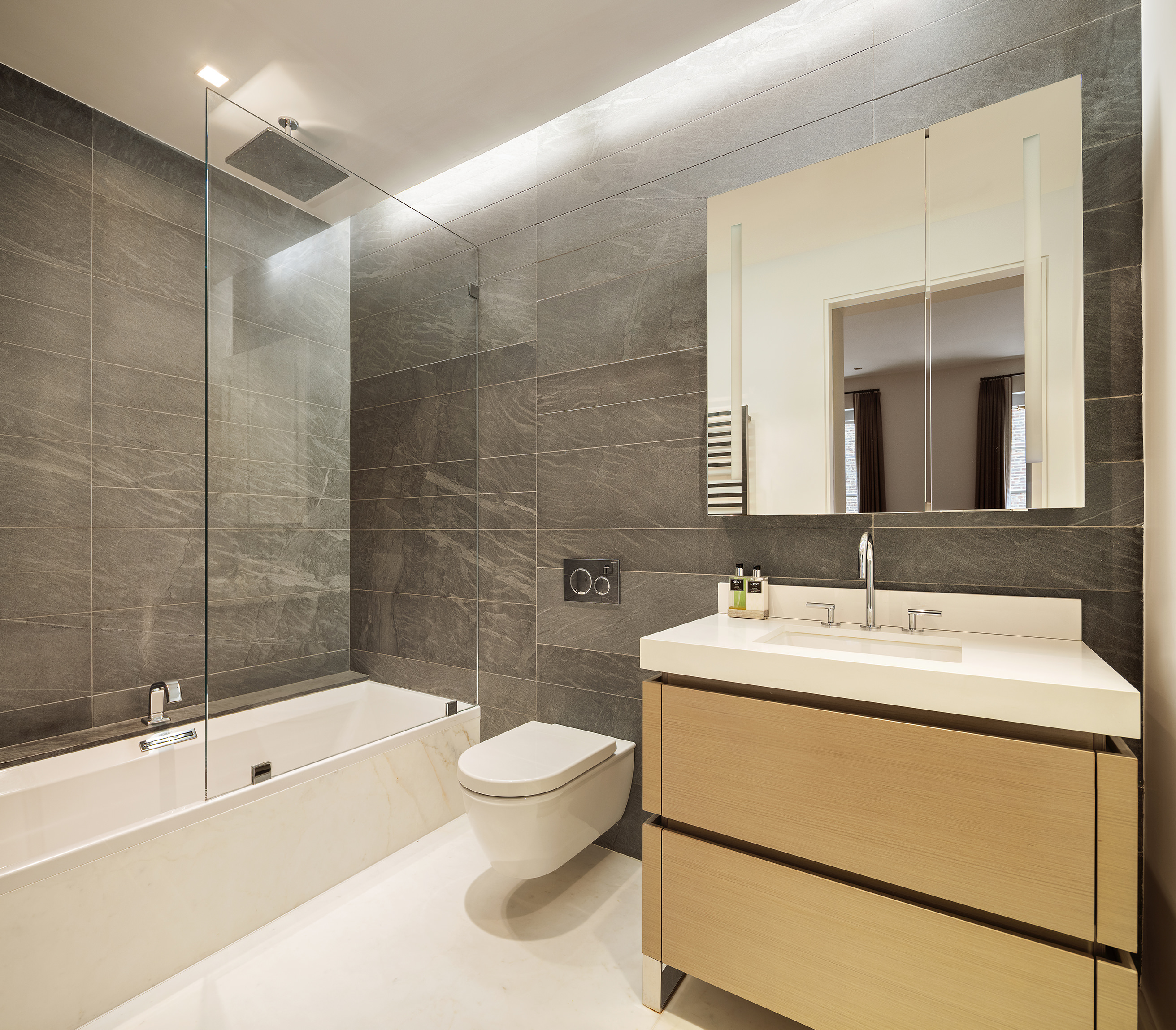 53 Greene Street, Unit 3 Manhattan, NY 10013 - Photo 18 of 22 a bathroom with a sink toilet and shower