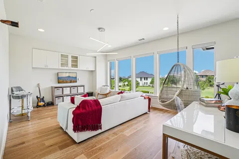 a living room with furniture and a wooden floor
