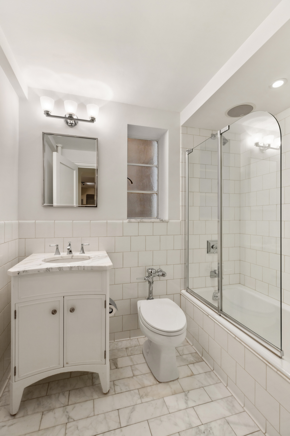 110 East 87th Street, Unit 2C Manhattan, NY 10128 - Photo 5 of 13 a bathroom with a toilet sink and shower
