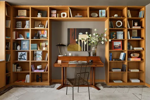 a view of a livingroom with furniture and a window