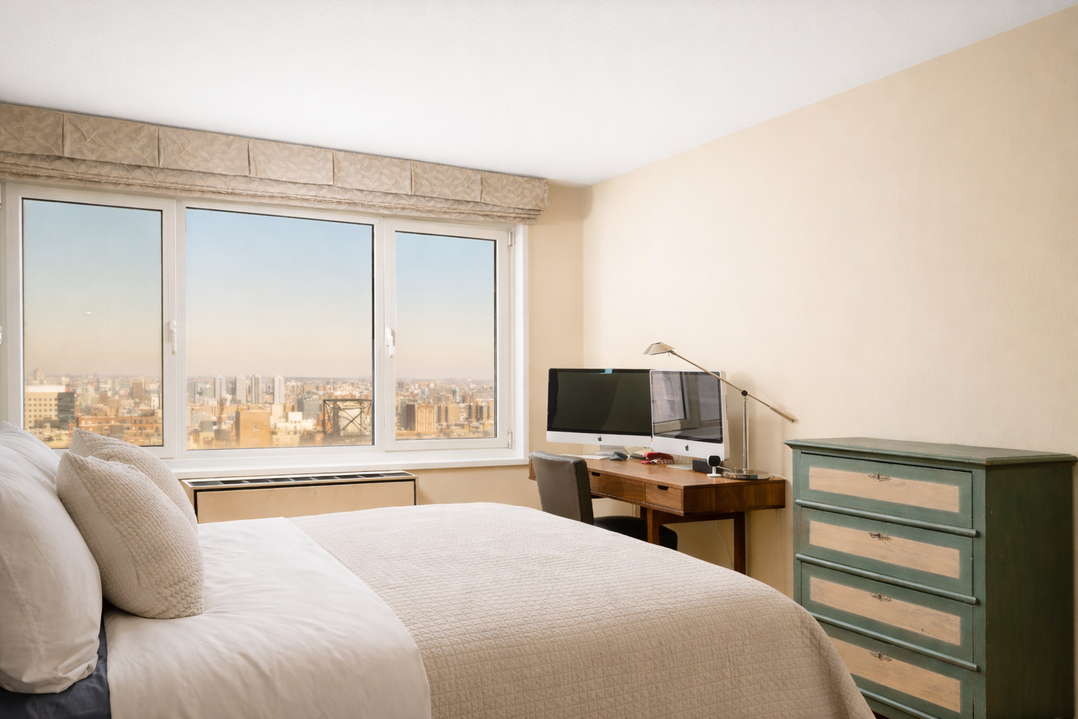 50 East 89th Street, Unit 31C Manhattan, NY 10128 - Photo 9 of 18 a bedroom with a bed and a large window