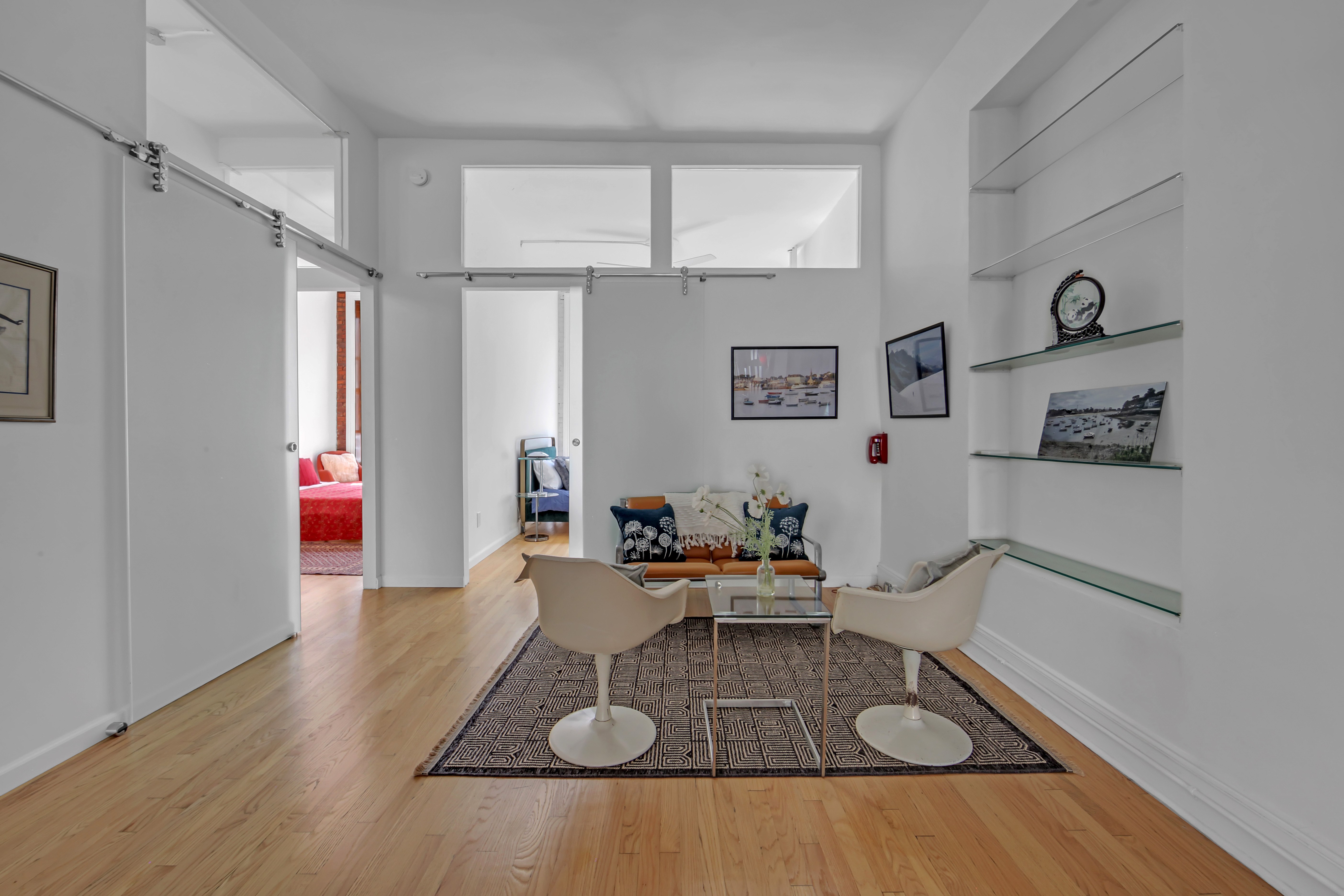 56 East 11th Street, Unit 7 Manhattan, NY 10003 - Photo 10 of 16 a living room with furniture and wooden floor