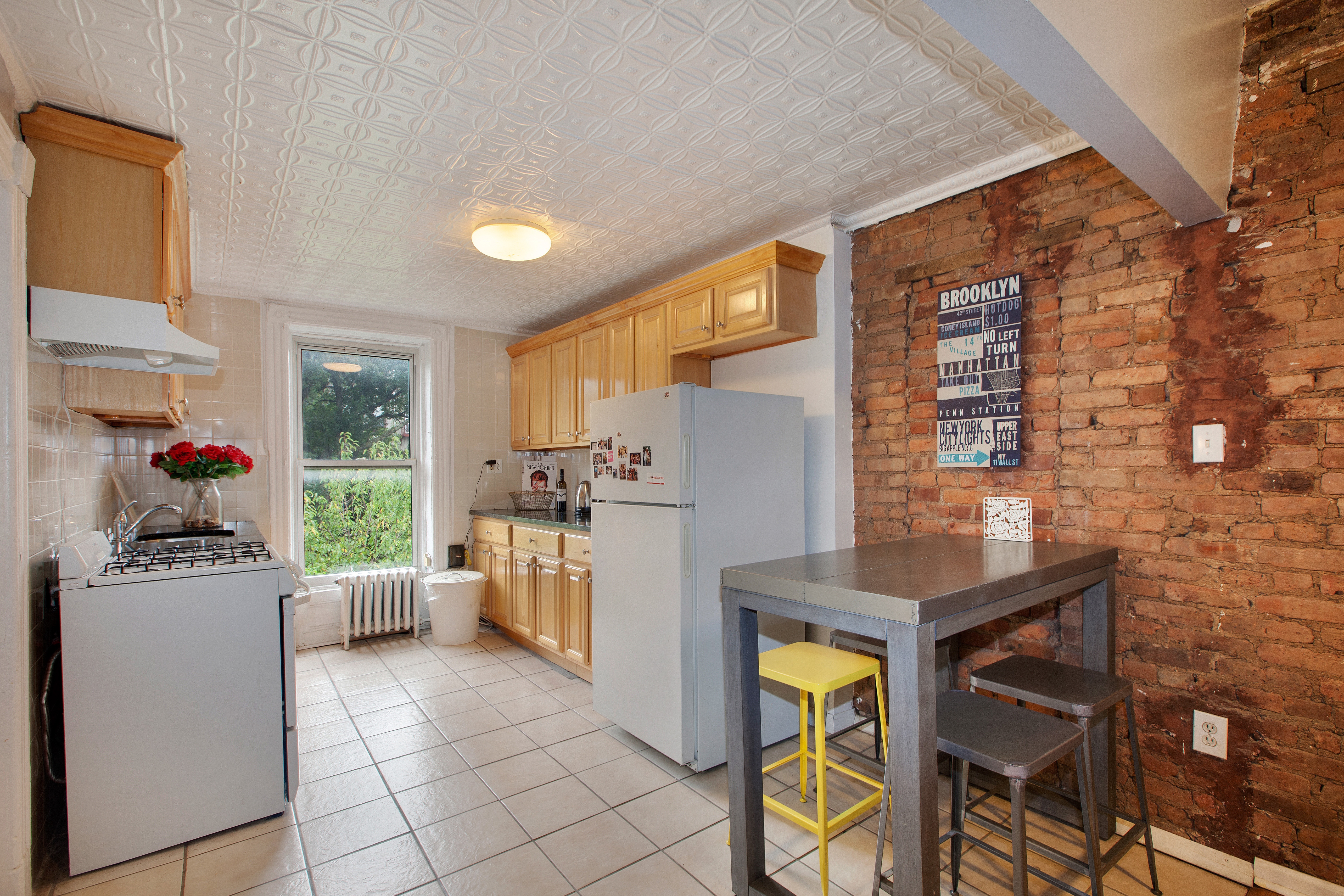 250 Saint Marks Avenue, Unit 3 Brooklyn, NY 11238 - Photo 3 of 8 a kitchen with a refrigerator and a stove