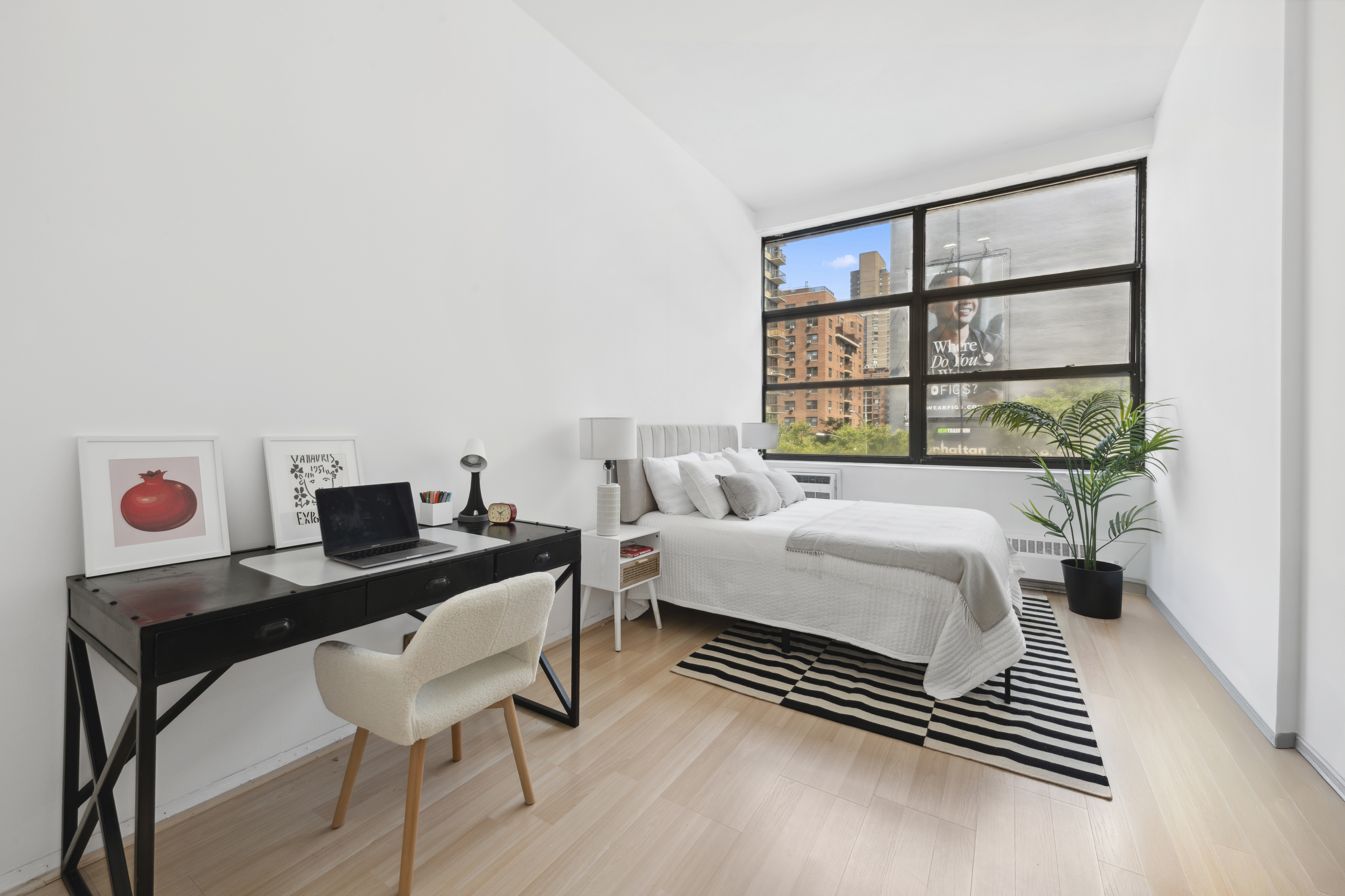 350 East 62nd Street, Unit 2B Manhattan, NY 10065 - Photo 2 of 10 a bedroom with a bed and a large window