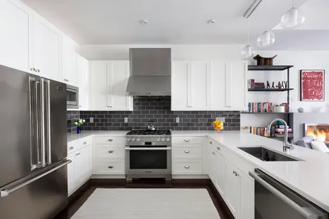 a kitchen with stainless steel appliances a sink stove and refrigerator