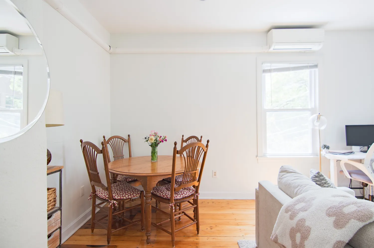 a view of a dining room with furniture and a window