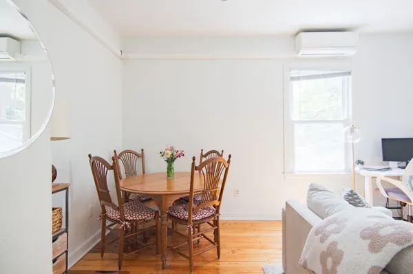 a view of a dining room with furniture and a window