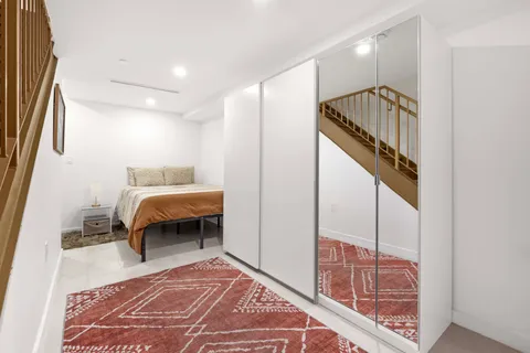 a bedroom with a bed and a mirror