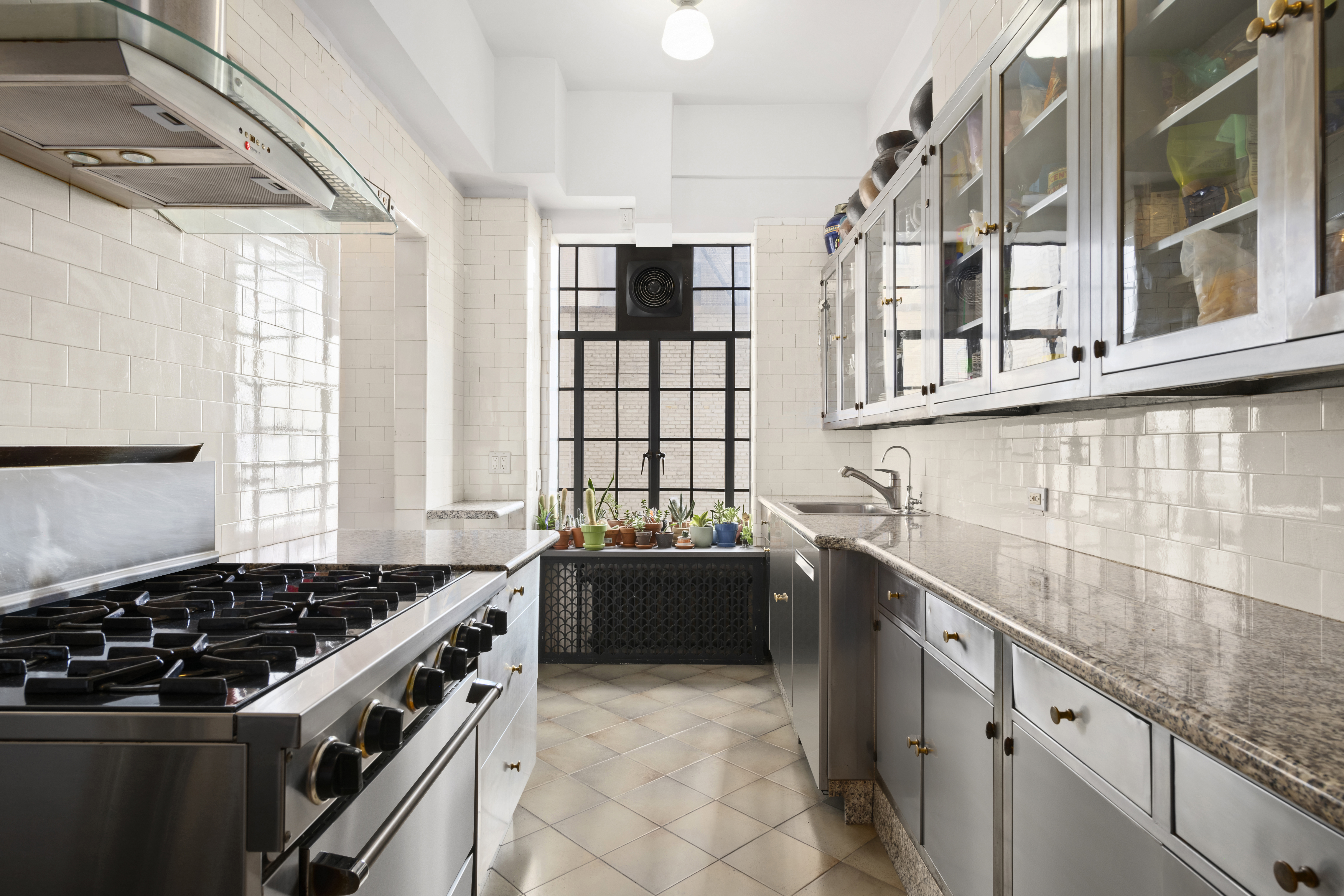 300 Central Park West, Unit 21G Manhattan, NY 10024 - Photo 9 of 21 a kitchen that has a sink and a stove