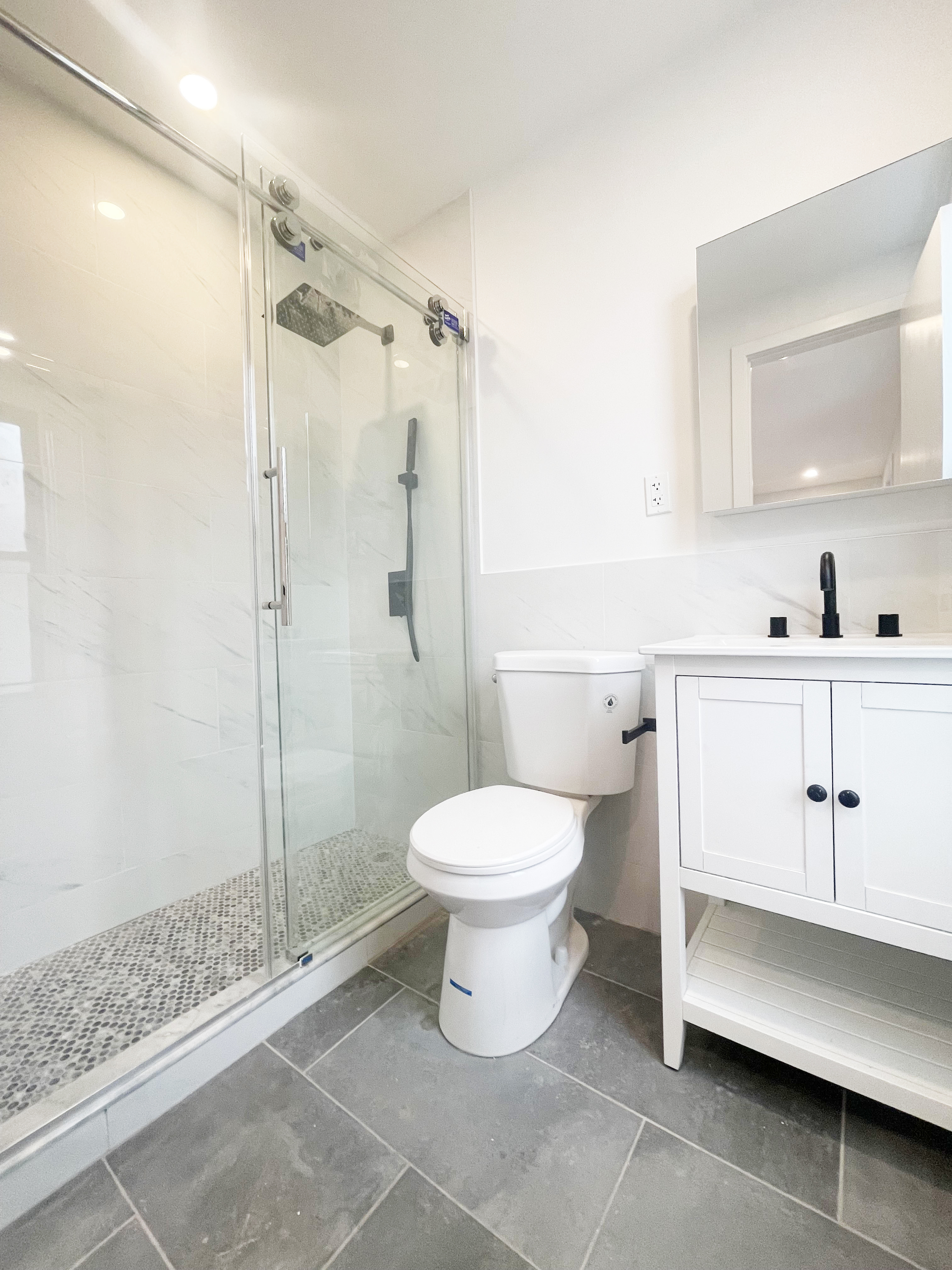 297 3rd Avenue, Unit PH Brooklyn, NY 11215 - Photo 4 of 9 a bathroom with a toilet sink and shower