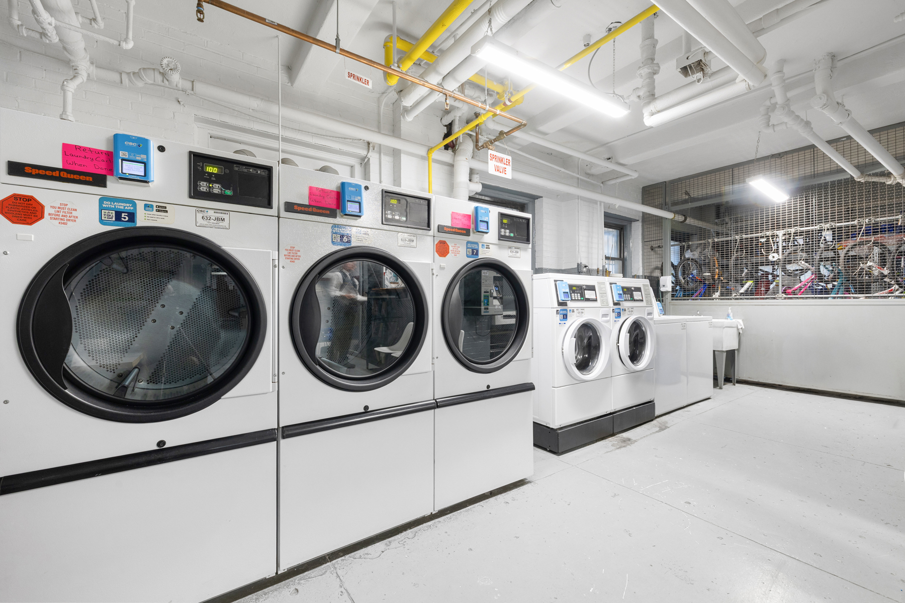 322 West 72nd Street, Unit 3D Manhattan, NY 10023 - Photo 16 of 19 a utility room with dryer washer and a view of living room