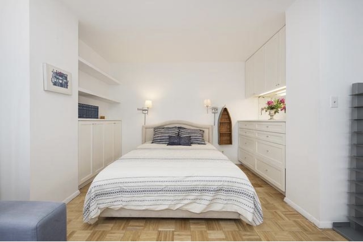 201 West 74th Street, Unit 16A Manhattan, NY 10023 - Photo 3 of 13 a bedroom with a bed and a refrigerator
