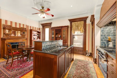a kitchen with stainless steel appliances granite countertop a stove refrigerator and cabinets