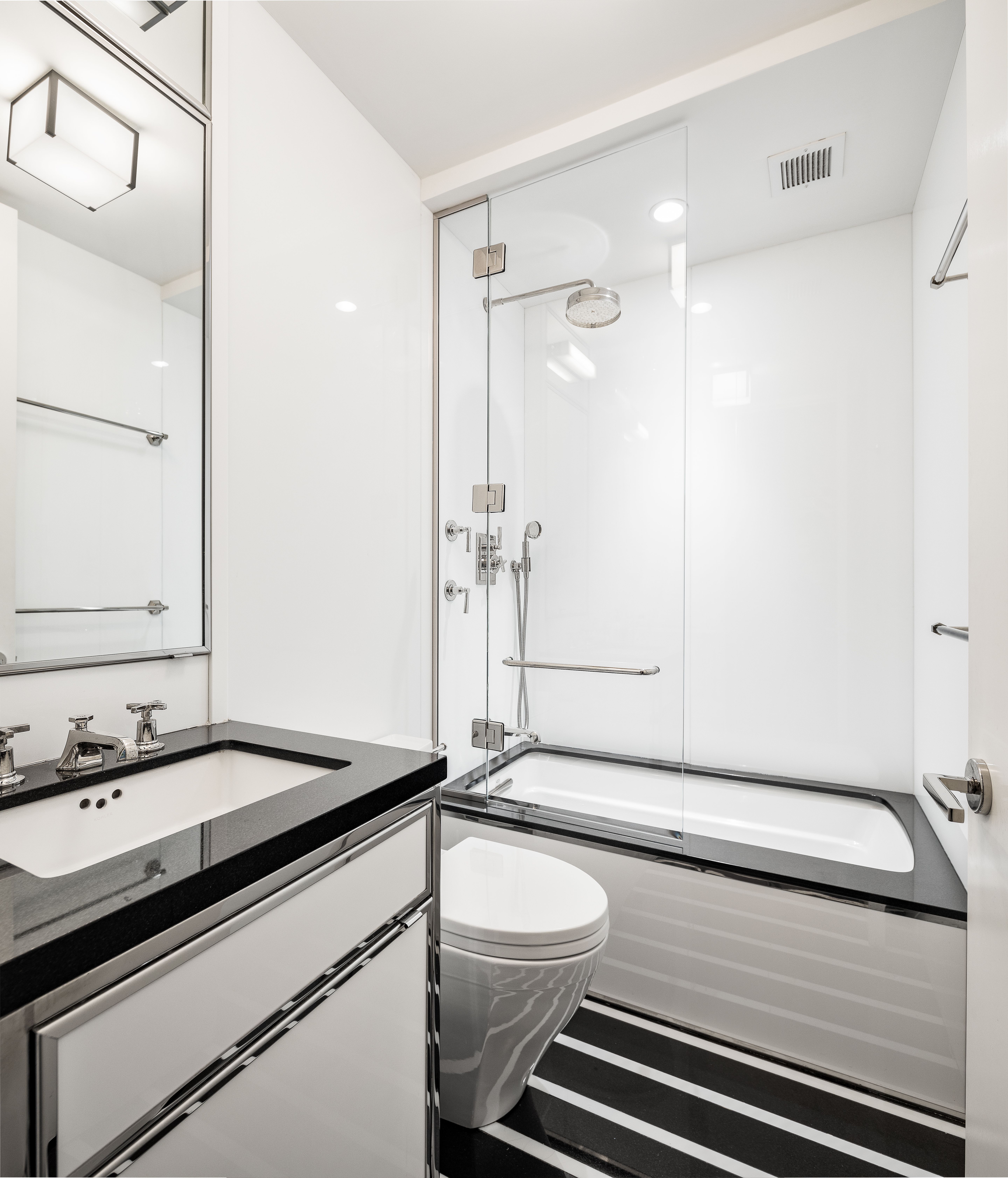 1001 5th Avenue, Unit 4C Manhattan, NY 10028 - Photo 6 of 11 a bathroom with a sink and a mirror