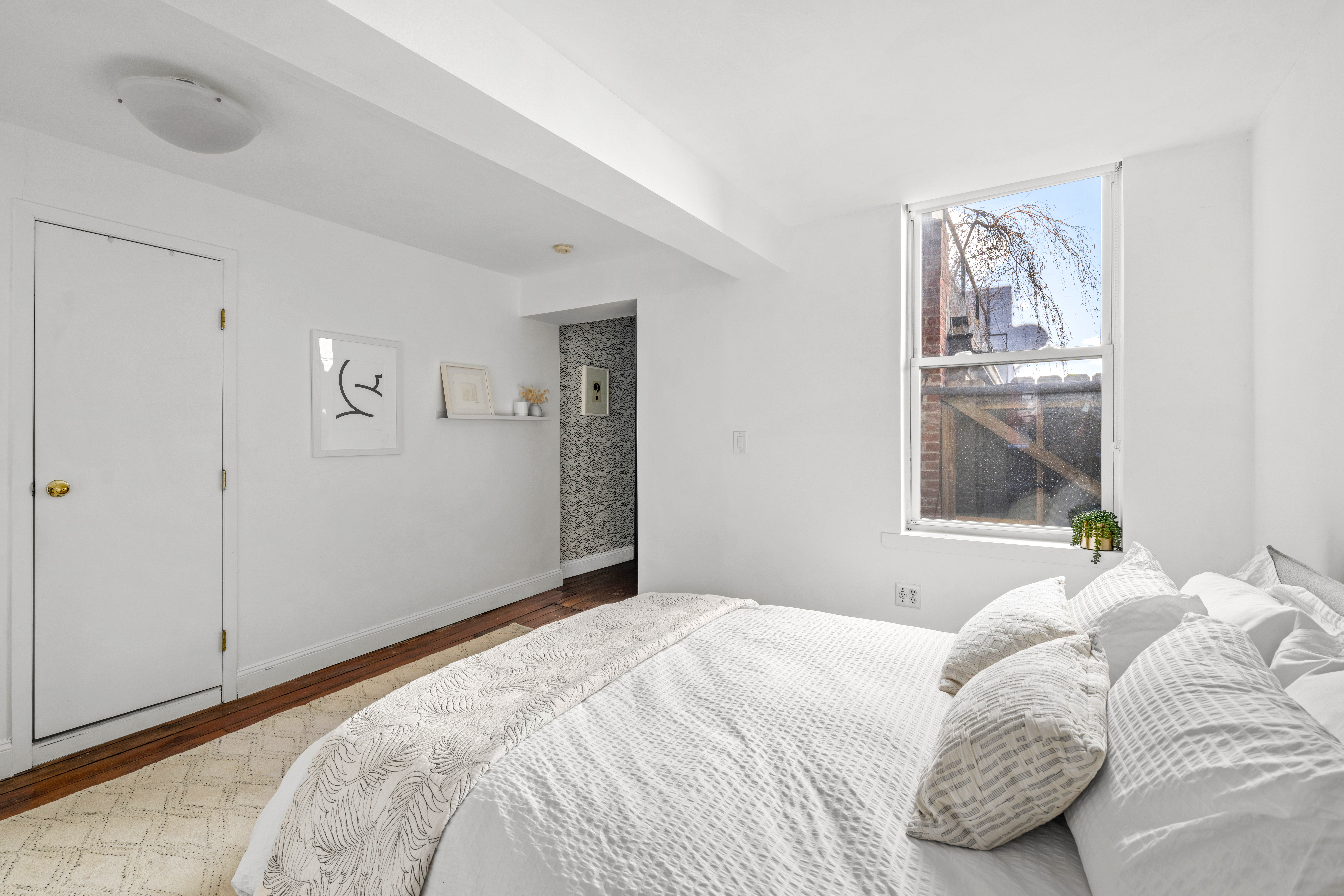 24 Harrison Street, Unit 3 Manhattan, NY 10013 - Photo 7 of 11 a bedroom with a bed and a window