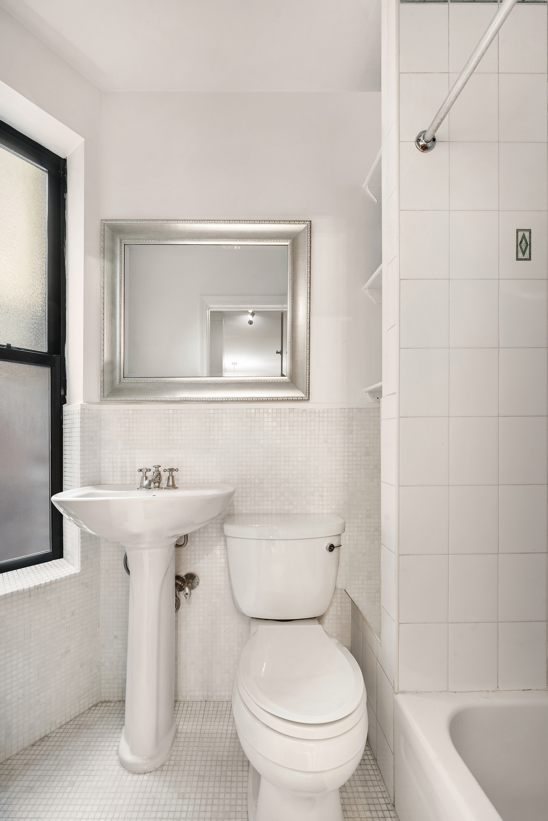 28 Perry Street, Unit 4E Manhattan, NY 10014 - Photo 8 of 9 a bathroom with a sink a toilet and shower